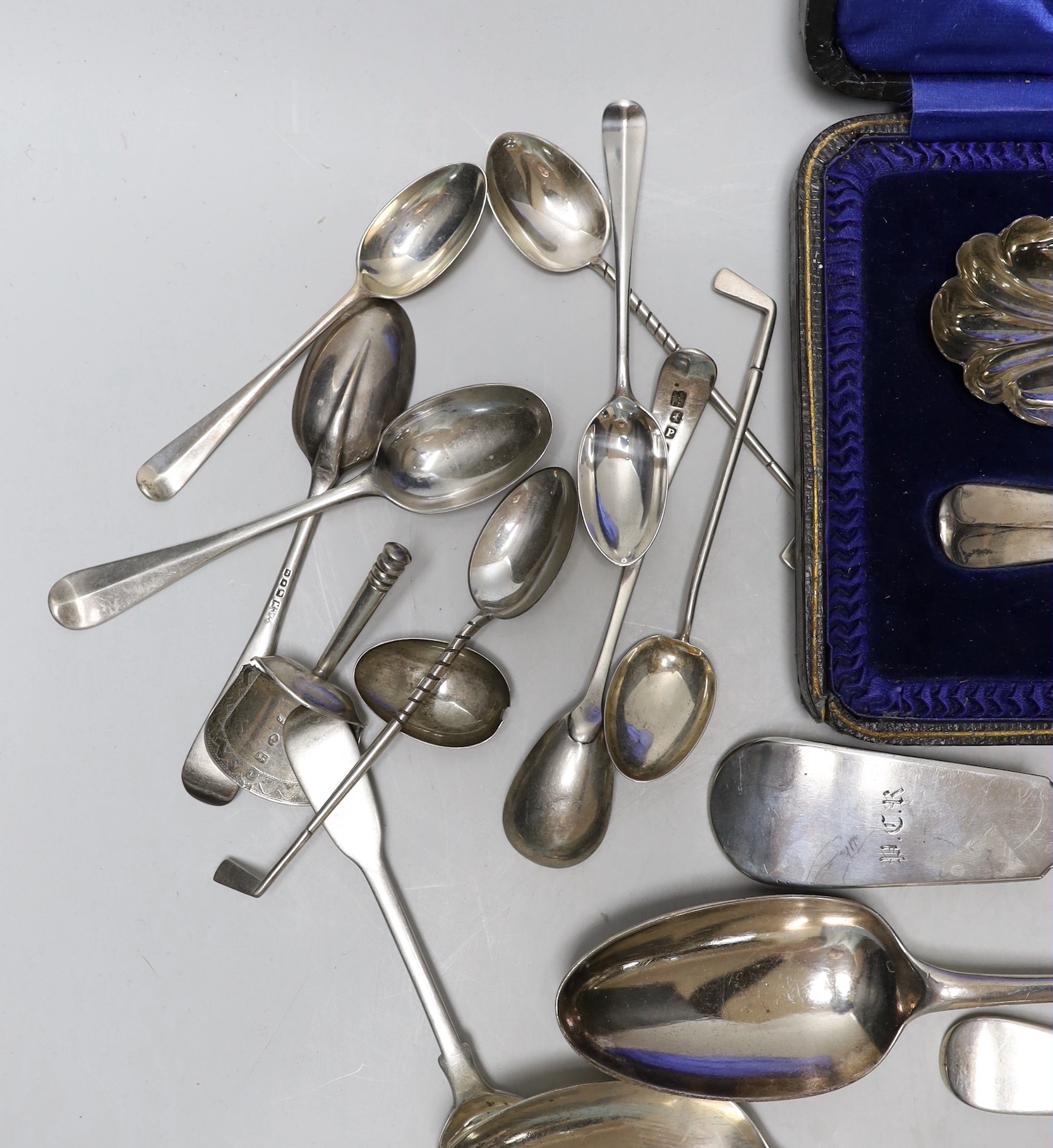 A Victorian Irish silver fiddle pattern basting spoon, Dublin, 1844, three George III tablespoons, a pair of later cased serving spoons and sundry tea, coffee and golf spoons, 23.7oz.